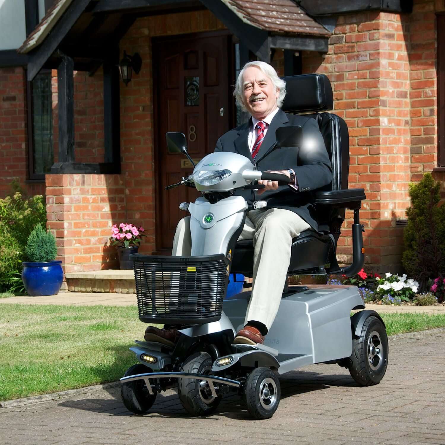 Quingo Toura 2 Mobility Scooter - left front outdoors with model